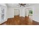 Spacious living room with hardwood floors, decorative trim, and archways to other rooms at 302 Eastleigh Dr, Belleair, FL 33756