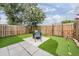 Landscaped backyard featuring artificial turf, putting green, and entertainment area at 3029 Brookfield Ln, Clearwater, FL 33761
