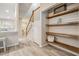 Bright entryway features wood floors and a built-in display area with wooden shelving at 3029 Brookfield Ln, Clearwater, FL 33761