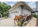 Charming home featuring a clean white garage door, beautiful landscaping, and a well-maintained exterior at 3029 Brookfield Ln, Clearwater, FL 33761