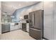 Well-equipped kitchen with stainless steel appliances, stylish gray cabinets, and modern lighting fixtures at 3029 Brookfield Ln, Clearwater, FL 33761