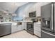 Modern kitchen with gray cabinets, stainless steel appliances, decorative backsplash, and an open layout at 3029 Brookfield Ln, Clearwater, FL 33761