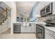 Modern kitchen featuring stainless steel appliances, a farmhouse sink, sleek countertops, and stylish cabinets at 3029 Brookfield Ln, Clearwater, FL 33761