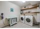 Well-equipped laundry room with modern washer/dryer units and ample storage at 3029 Brookfield Ln, Clearwater, FL 33761