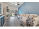 Comfortable living room with vaulted ceilings, a ceiling fan, modern sofa, and sliding glass doors to the patio at 3029 Brookfield Ln, Clearwater, FL 33761