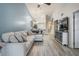Bright open-plan living area with light wood floors, vaulted ceiling, and modern furnishings and decor at 3029 Brookfield Ln, Clearwater, FL 33761