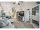 Bright living area showing modern decor, wood floors, and vaulted ceiling leading into dining and kitchen at 3029 Brookfield Ln, Clearwater, FL 33761