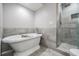 Bright main bathroom features a classic clawfoot tub and walk-in shower at 3029 Brookfield Ln, Clearwater, FL 33761