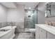 Main bathroom features clawfoot tub and walk-in shower with gray tile surround at 3029 Brookfield Ln, Clearwater, FL 33761