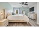 Light-filled main bedroom features wood floors and a light green accent wall at 3029 Brookfield Ln, Clearwater, FL 33761