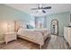 Light-filled main bedroom with wood floors, ceiling fan, and ensuite bathroom entrance at 3029 Brookfield Ln, Clearwater, FL 33761
