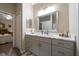 Modern bathroom with dual sinks, gray cabinets, marble countertop, and plenty of storage at 3137 Banyan Hill Ln, Land O Lakes, FL 34639