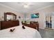 Beautifully decorated bedroom with bed, dresser, and TV for comfortable relaxation at 3137 Banyan Hill Ln, Land O Lakes, FL 34639