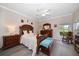 Well-lit bedroom featuring a ceiling fan, a comfortable bed, and an array of stylish furniture at 3137 Banyan Hill Ln, Land O Lakes, FL 34639