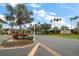 Elegant community entrance with lush landscaping and decorative signage at 3137 Banyan Hill Ln, Land O Lakes, FL 34639