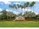 Plantation Palms Golf Club entrance featuring lush landscaping and decorative signage at 3137 Banyan Hill Ln, Land O Lakes, FL 34639