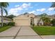 Charming single-Gathering home featuring a manicured lawn and a two car garage at 3137 Banyan Hill Ln, Land O Lakes, FL 34639