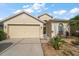 Welcoming home exterior featuring a two-car garage and maintained lawn at 3137 Banyan Hill Ln, Land O Lakes, FL 34639