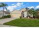 Beautiful one-story home with a well-manicured lawn and a two-car garage at 3137 Banyan Hill Ln, Land O Lakes, FL 34639