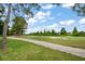 Scenic view of a lush green golf course with mature trees under a bright blue sky at 3137 Banyan Hill Ln, Land O Lakes, FL 34639