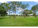 Expansive green golf course fairway with mature trees under a bright sky at 3137 Banyan Hill Ln, Land O Lakes, FL 34639