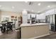 Eat-in kitchen boasts stainless steel appliances, light cabinets, and a center island at 3137 Banyan Hill Ln, Land O Lakes, FL 34639