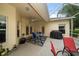 Covered patio with furniture overlooks landscaped backyard at 3137 Banyan Hill Ln, Land O Lakes, FL 34639