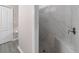 Modern shower with gray mosaic floor, marble style tile, and sleek fixtures at 3137 Banyan Hill Ln, Land O Lakes, FL 34639