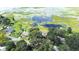 Aerial view of the property showcasing lush greenery, the lake, and surrounding neighborhood at 35836 Lakeshore Dr, Dade City, FL 33525