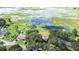Aerial view of neighborhood and home with lake and dock at 35836 Lakeshore Dr, Dade City, FL 33525