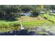 Aerial view of the property with a dock, in-ground pool and shed near the lake at 35836 Lakeshore Dr, Dade City, FL 33525