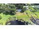 A clear aerial shot shows the property with a pool, large yard, and dock access to the lake at 35836 Lakeshore Dr, Dade City, FL 33525