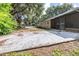 View of a concrete patio off the back of house overlooking the spacious backyard at 35836 Lakeshore Dr, Dade City, FL 33525