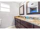 Bathroom showcases a granite countertop, dual sinks, and a dark wood vanity with ample storage at 35836 Lakeshore Dr, Dade City, FL 33525