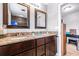 Bathroom featuring double vanity sinks with granite countertops and modern fixtures at 35836 Lakeshore Dr, Dade City, FL 33525