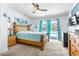 Bedroom with pool access, decorative anchor, wood frame bed, and matching furnishings at 35836 Lakeshore Dr, Dade City, FL 33525