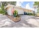 Spacious driveway leading to a two-car garage and features an American Flag at 35836 Lakeshore Dr, Dade City, FL 33525