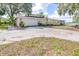 Spacious driveway leading to a two-car garage and features an American Flag at 35836 Lakeshore Dr, Dade City, FL 33525