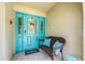 Inviting entrance with a colorful front door and a cozy seating area at 35836 Lakeshore Dr, Dade City, FL 33525