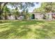 Charming single-story home featuring lush landscaping and an inviting front yard at 35836 Lakeshore Dr, Dade City, FL 33525