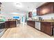 Bright kitchen with stainless steel appliances, dark cabinetry, and tile flooring at 35836 Lakeshore Dr, Dade City, FL 33525