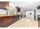 Spacious kitchen featuring granite countertops, and dark wood cabinetry at 35836 Lakeshore Dr, Dade City, FL 33525