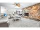 Inviting living room with stone fireplace and an open view into the kitchen at 35836 Lakeshore Dr, Dade City, FL 33525