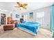 Bright bedroom with ample natural light, ceiling fan, and an adjacent sitting area at 35836 Lakeshore Dr, Dade City, FL 33525