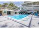 Inviting in-ground pool featuring a large screened enclosure, slide, and spacious deck for entertaining guests at 35836 Lakeshore Dr, Dade City, FL 33525