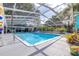 Beautiful screened-in pool with slide and inviting seating area at 35836 Lakeshore Dr, Dade City, FL 33525