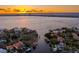 Sunset aerial shot showcasing a waterfront lot with panoramic views of the water and city skyline at 38 Ladoga Ave, Tampa, FL 33606