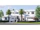 Picturesque two-story home featuring a white exterior, brick accents, palm trees, and a well-kept front lawn at 38 Ladoga Ave, Tampa, FL 33606