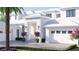 Elegant home exterior with a gabled roof, two-car garage, a paver driveway, and well-manicured landscaping at 38 Ladoga Ave, Tampa, FL 33606