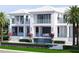 Gorgeous waterfront home featuring a pool with waterfall, covered balconies, and meticulous landscaping at 38 Ladoga Ave, Tampa, FL 33606